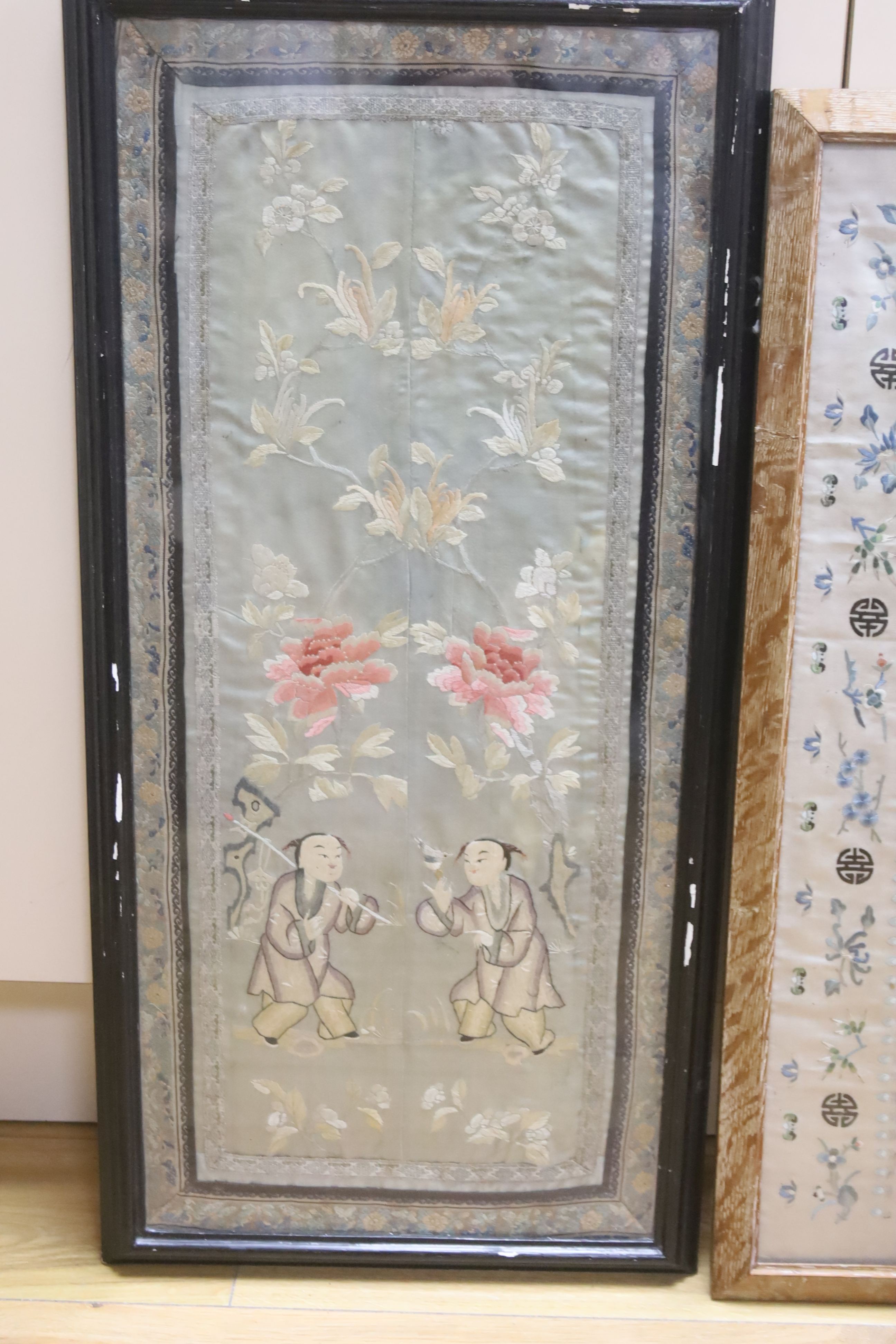 A Chinese embroidered sleeve band and a pair of embroidered sleeve bands (in one frame), largest 64 x 28cm